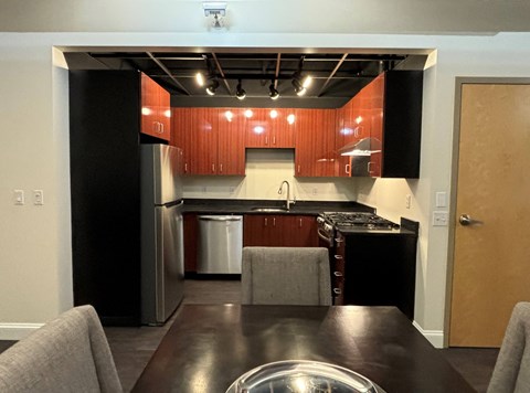 Contemporary Dining Area and all electric kitchen at The Lofts at Elk Terminal, New York, 14204